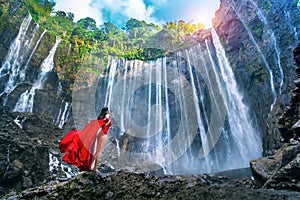 Young woman standing at Air Tumpak Sewu Waterfall, Indonesia