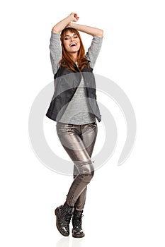 Young Woman Is Standing With Arms Raised And Laughing