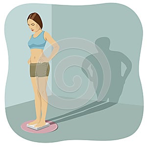 Young woman standing on bathroom scale with her shadow shows her distorted body image photo