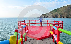 Young woman standing on the cliff bridge