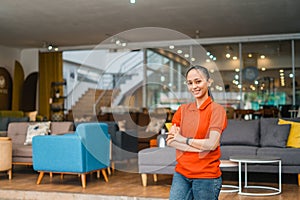 Young woman standing in front of many couch in furniture store department