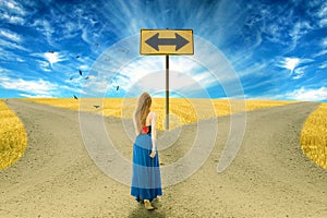 Young woman standing in front of two roads