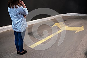 Young woman standing in front of two roads