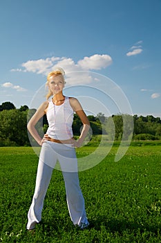 Young woman standing on a green grass