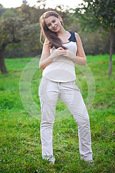 Young woman standing on green grass