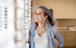 Young woman standing in the kitchen at home