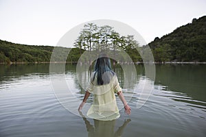 Young woman standing in lake