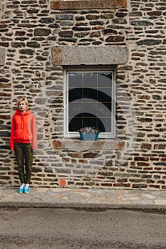 young woman standing near old stone building mont saint