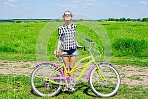 Young woman standing next to her bike