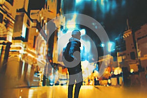 Young woman standing in night city photo