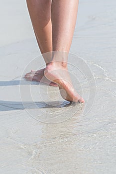 Young woman standing at relax pose or freedom pose or chill pose on the beach