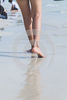 Young woman standing at relax pose or freedom pose or chill pose on the beach