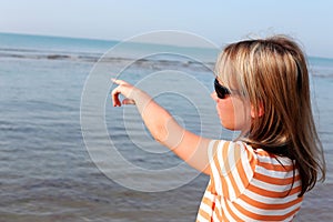 Young woman standing by the sea