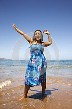 Young woman standing on shore.