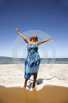 Young woman standing in shore.