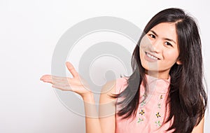 Young woman standing showing hand presenting product