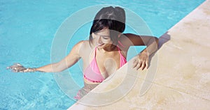 young woman standing in a swimming pool