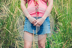 Young woman standing in tall grass