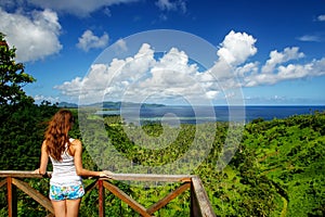 Young woman standing at the viewpoint in Bouma National Heritage