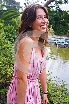 Young woman standing in a viewpoint to a local lake