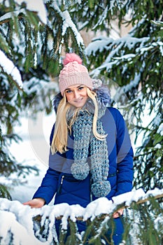 Young woman standing in winter forest