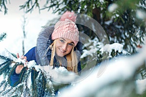 Young woman standing in winter forest