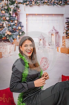 the woman in this photo is smiling with her lollipop