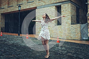 Young woman stands in the rain