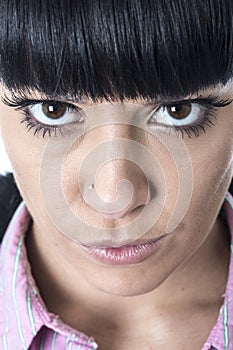 Young Woman Starring with Wide Brown Eyes Glaring photo