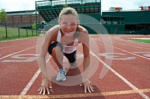 Young Woman at Starting Line on Running Track