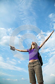 Young woman staying with raised hands