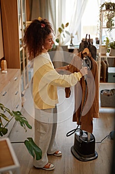 Young Woman Steaming Clothes