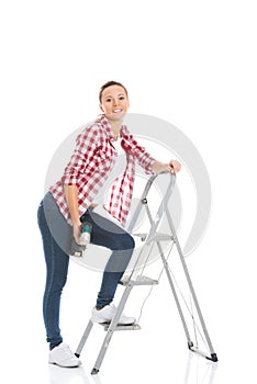 Young woman on step ladder.