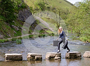 Young woman stepping stones to success metaphor photo