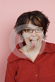 Young woman sticking out tongue