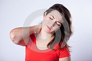 Young woman with stiff neck photo