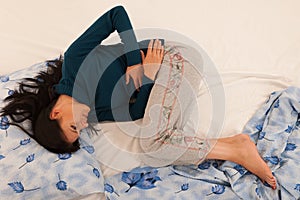 Young woman with stomach ache suffering isolated over white back