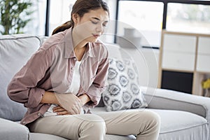 Young woman with stomach pain photo