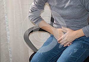Young woman with stomach pain. Health concept