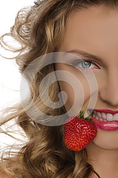 Young woman with strawberry teeth