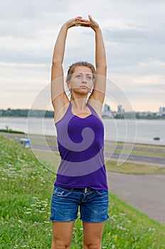 Young woman stretches.
