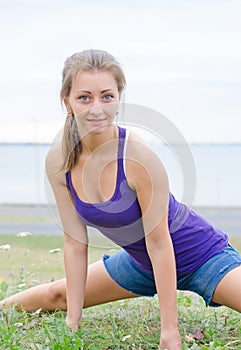 Young woman stretches.