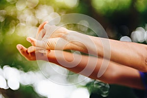 Young woman stretching arms outdoors