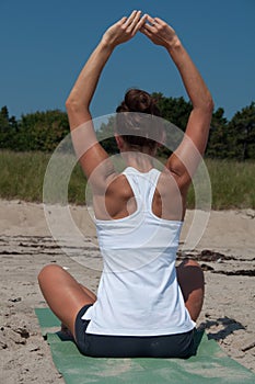 Young Woman Stretching on Beach