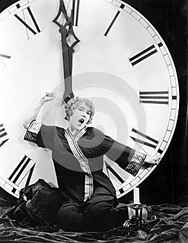 A young woman stretching in front of a giant clock striking midnight