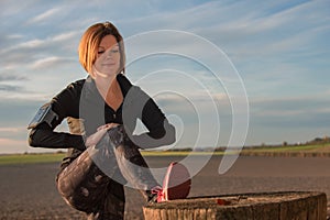 Young woman stretching with jogging clothes outdoors