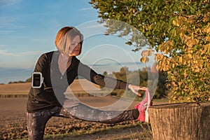 Young woman stretching with jogging clothes outdoors
