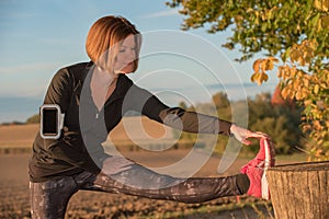 Young woman stretching with jogging clothes outdoors