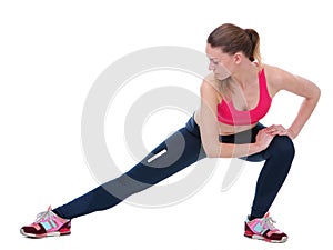 Young woman stretching leg muscles