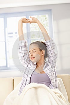 Young woman stretching in morning